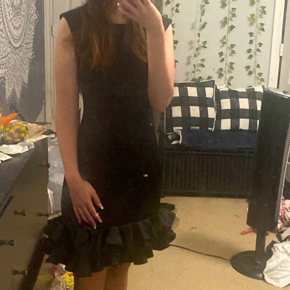 Black fitted dress w a little poof at the bottom. Size 4